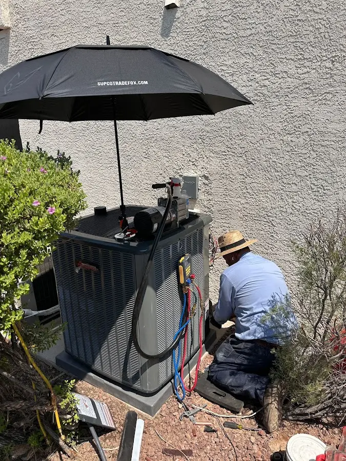 HVAC technician performing outdoor AC maintenance in Lathrop